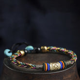 Pulsera tibetana ajustable tejida a mano con nudo de cinco colores para protección y buena suerte.