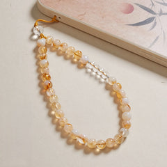 Gelber Quarz-Handyanhänger und stylisches Armband mit positiver Energie