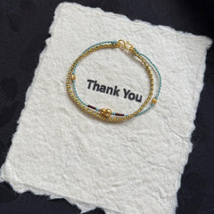 Pulsera de calabaza trenzada de doble capa | Cadena apilable con borlas, joyería artesanal