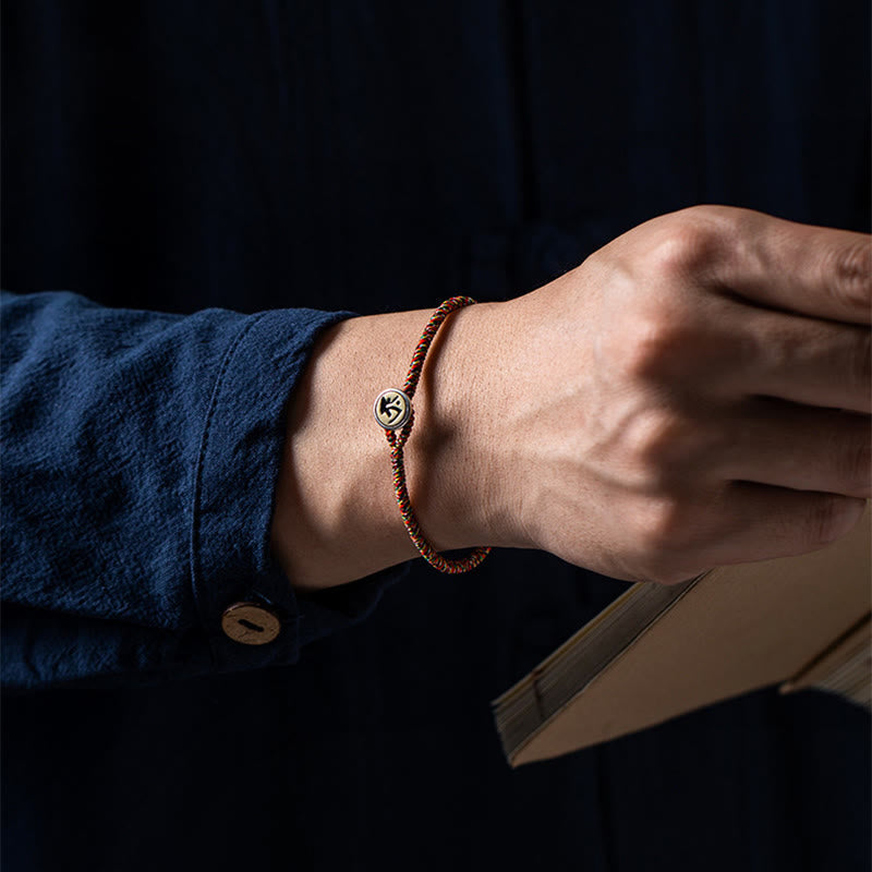 Cow Sanskrit symbol braided bracelet on hand